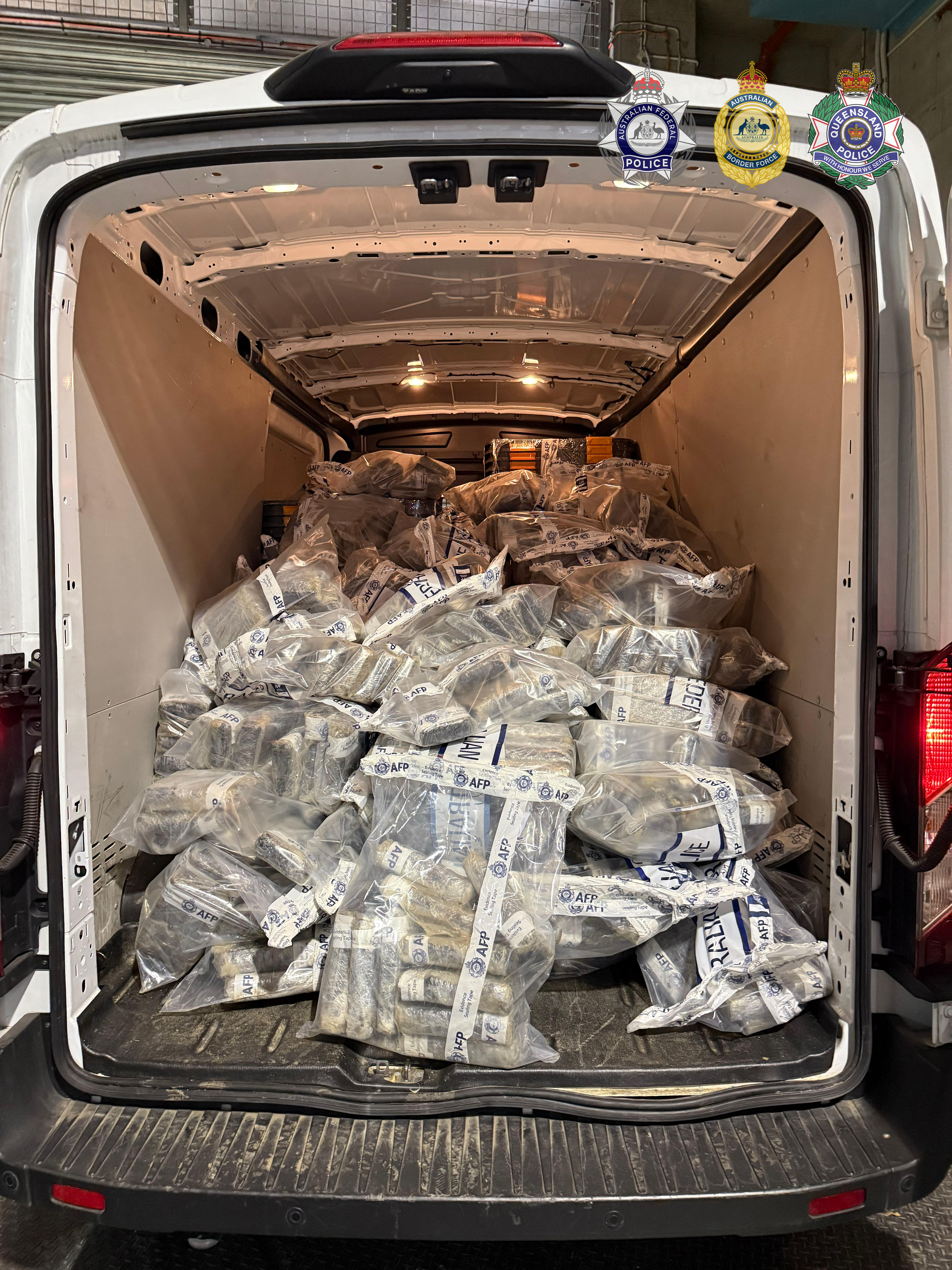 A large amount of packaged drugs inside the boot of a van, up to the vehicle's ceiling.