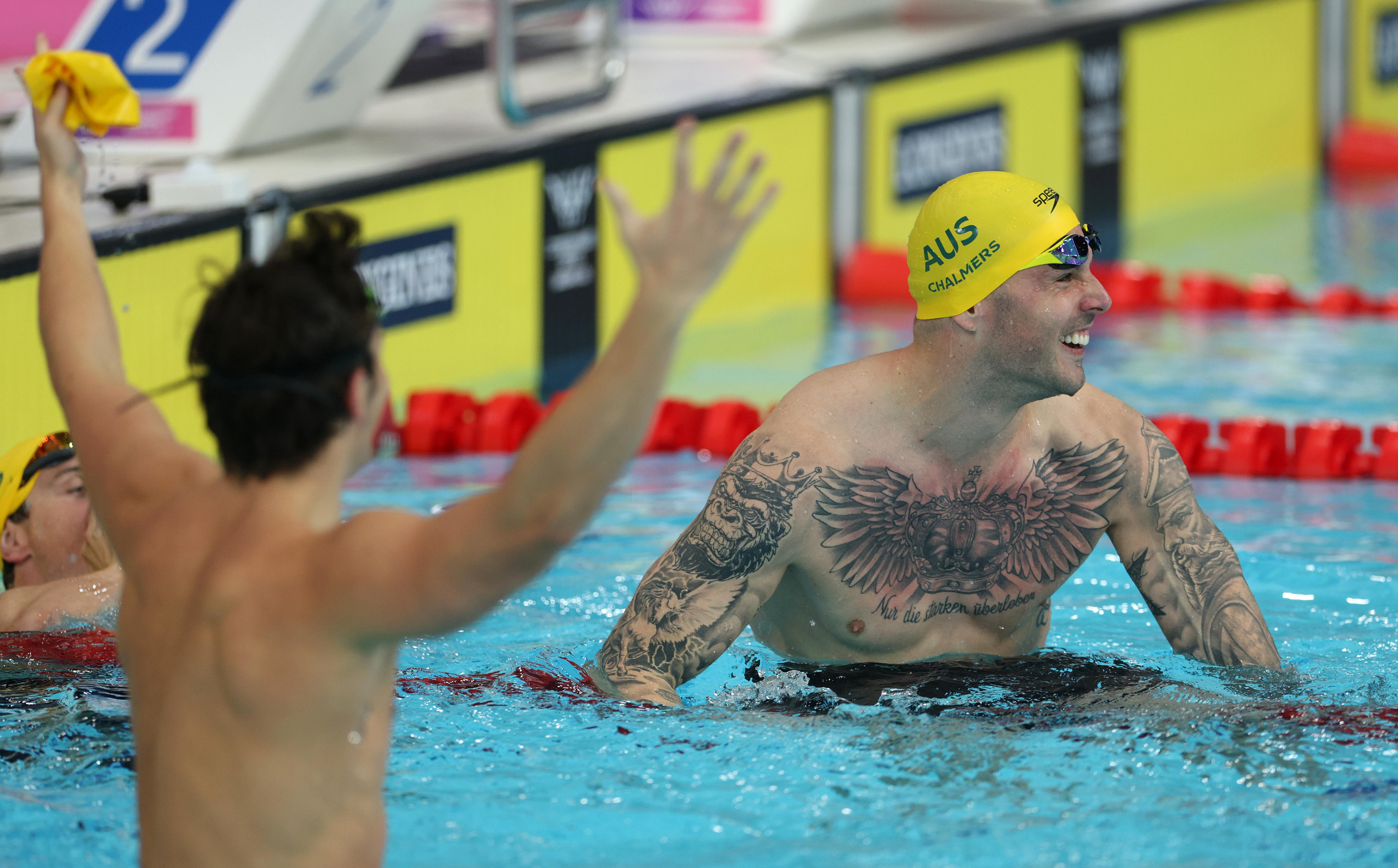 Kyle Chalmers and Ben Armbruster react after the men's 50m butterfly final at the Glasgow Commonwealth Games.