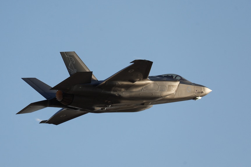 A F-35 fighter jet flies during a ceremony. 