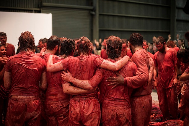 Blood-soaked performers embrace in a huddle at Hermann Nitsch's Hobart 150.Action show.