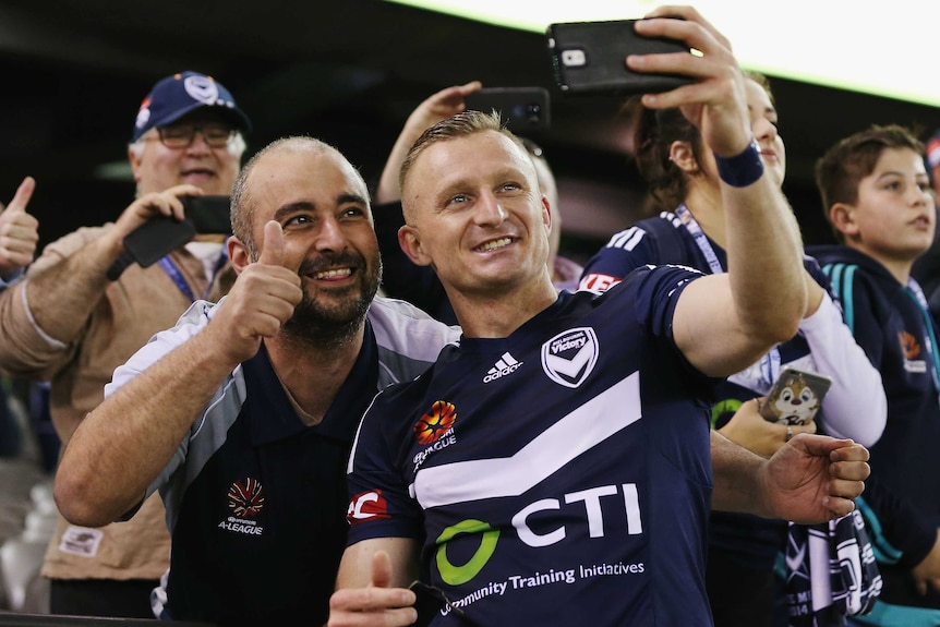Besart Berisha takes a selfie with a Melbourne Victory fan