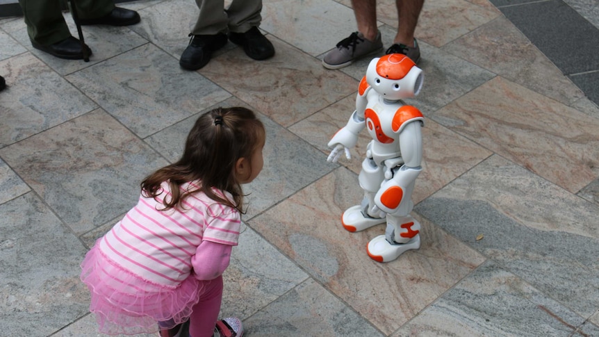 A little girl meets a Nao robot