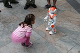 A little girl meets a Nao robot