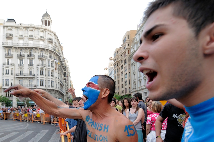 Protesters demonstrate around the closed City Hall square in Valencia.