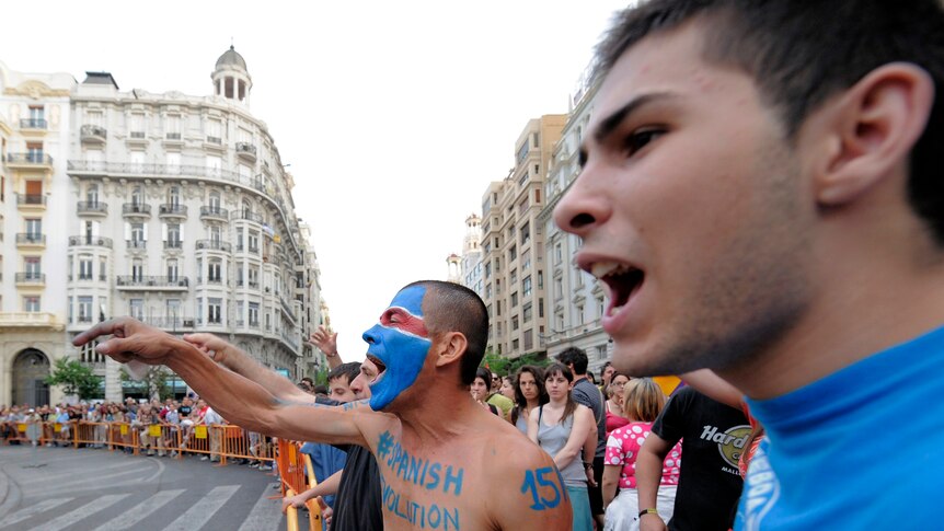 Protesters demonstrate around the closed City Hall square in Valencia.