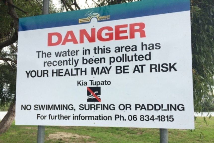 Sign saying "Danger, the water in this area has recently been polluted and your health may be at risk"