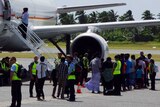 Group of 157 Sri Lankan asylum seekers boarding plane from Cocos Islands to Derby, Western Australia