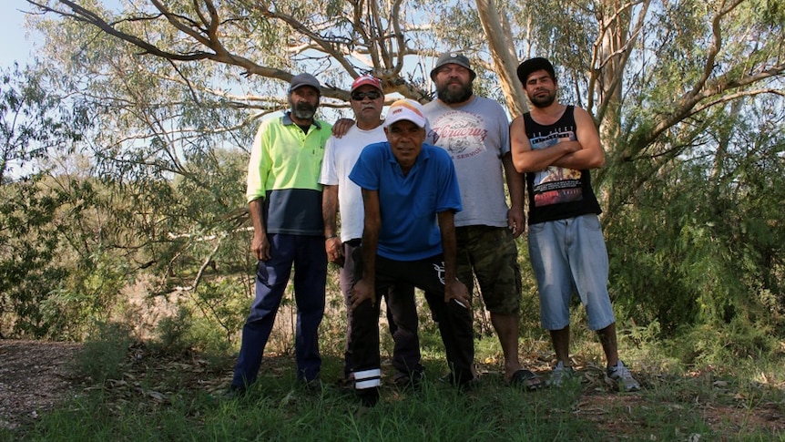 Five Aboriginal men pose for a photo in the banks of the Darling River.