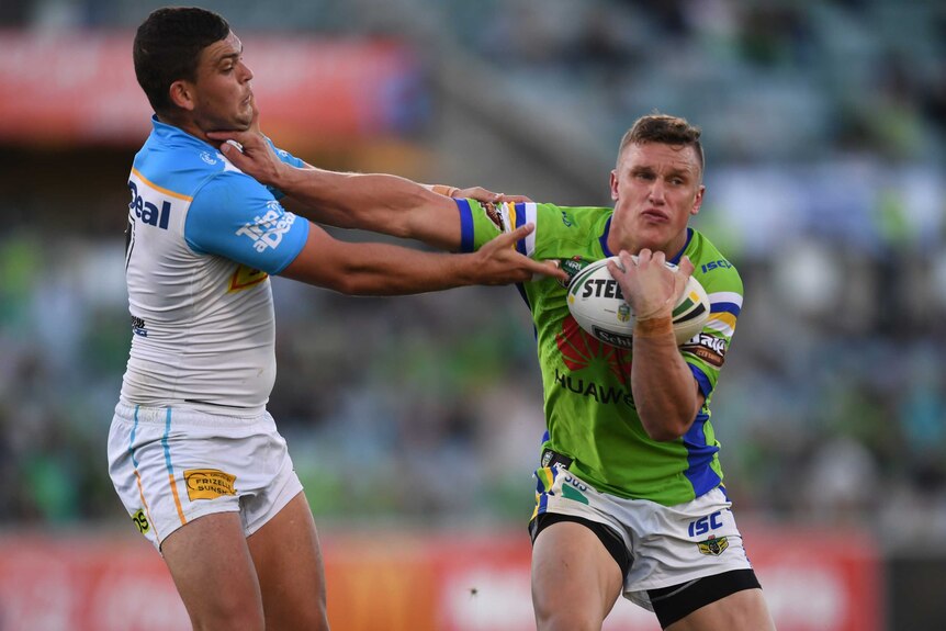 Jack Wighton tries to palm off the tackle of Ash Taylor.