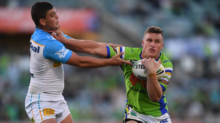 Jack Wighton tries to palm off the tackle of Ash Taylor.