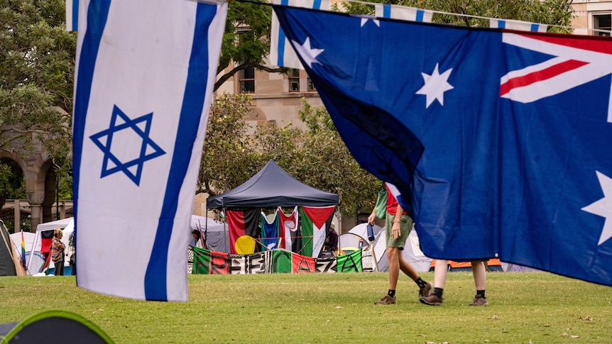 An Israeli and Australian flag next to a Free Gaza camp sign