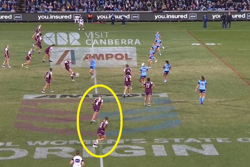 A screen grab of a moment in a rugby league match between New South Wales and Queensland.