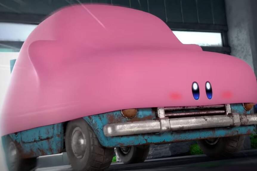 A giant pink video game creature with its mouth around a rusty car.