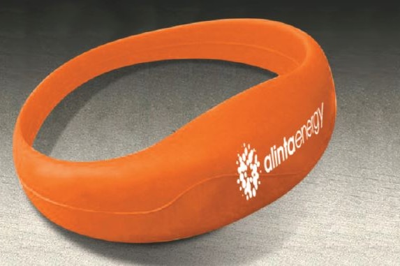 Close up of promotional orange wristband with Alinta Energy writing and logo.