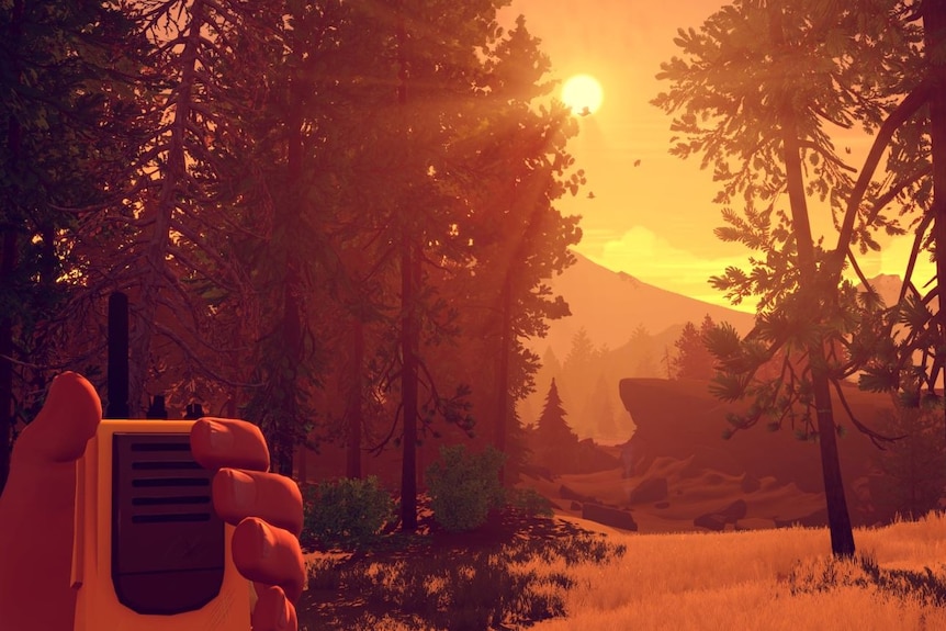 Screenshot from the video game Firewatch with a man's hand holding a two-way radio in front of a forest landscape at sunset