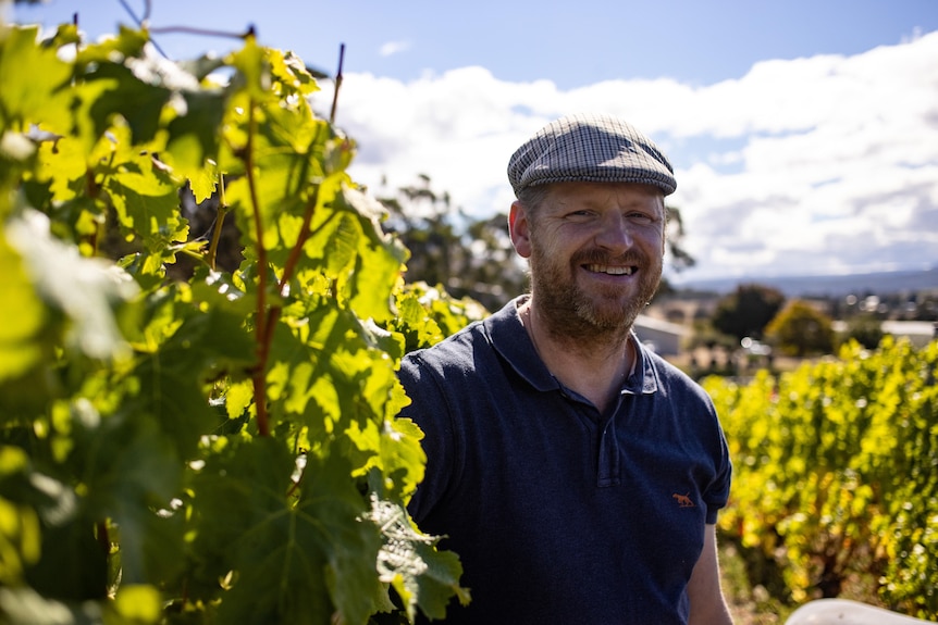 man smiling in vineyard