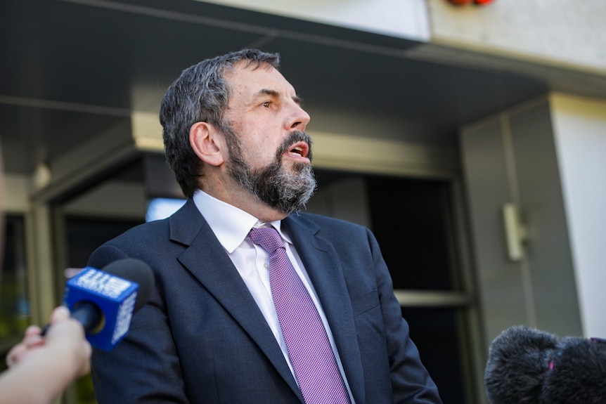 A mid-shot of WA Chief Health Officer Andy Robertson speaking outside state parliament.