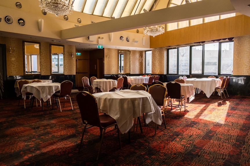 inside a restaurant with empty tables and chairs