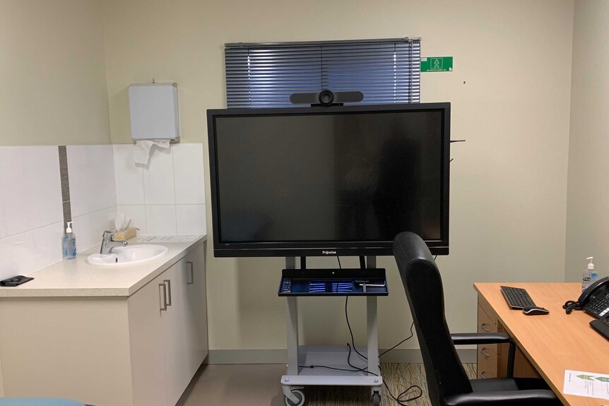 Picture of telehealth screen in a doctors surgery.