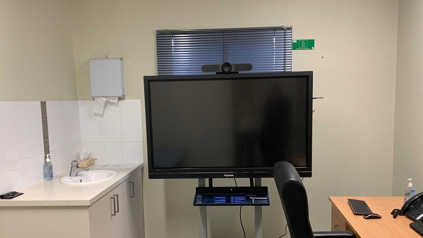 Picture of telehealth screen in a doctors surgery.