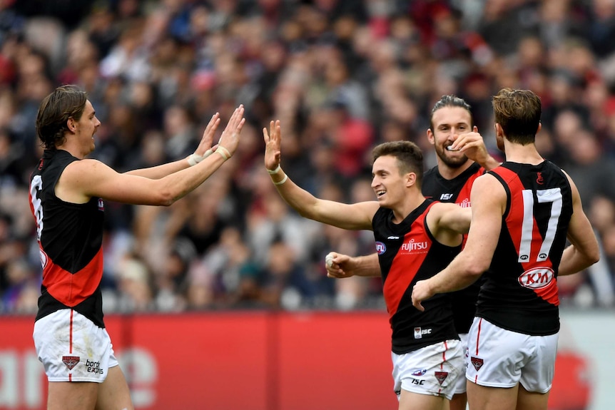 Orazio Fantasia of the Bombers (C) is congratulated after a goal against Collingwood at the MCG.