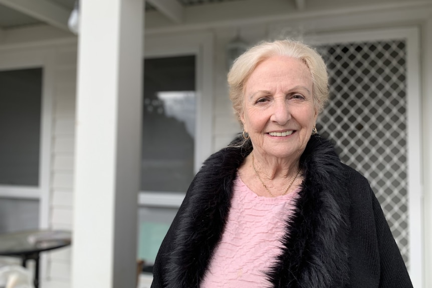 Loryn Clarke smiles at her front door