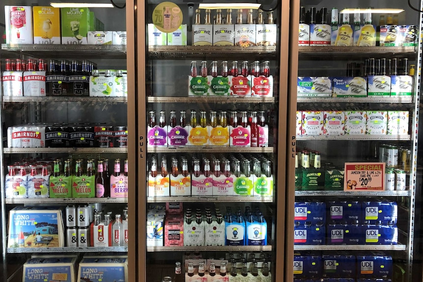 Colourfully wrapped alcohol in a fridge in a liquor store