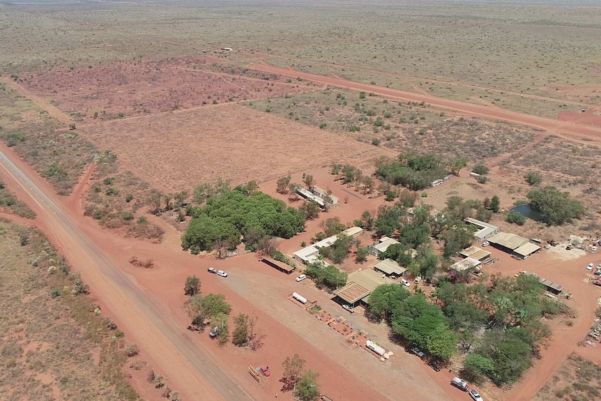 An aerial shot of a roadhouse in a dry landcape