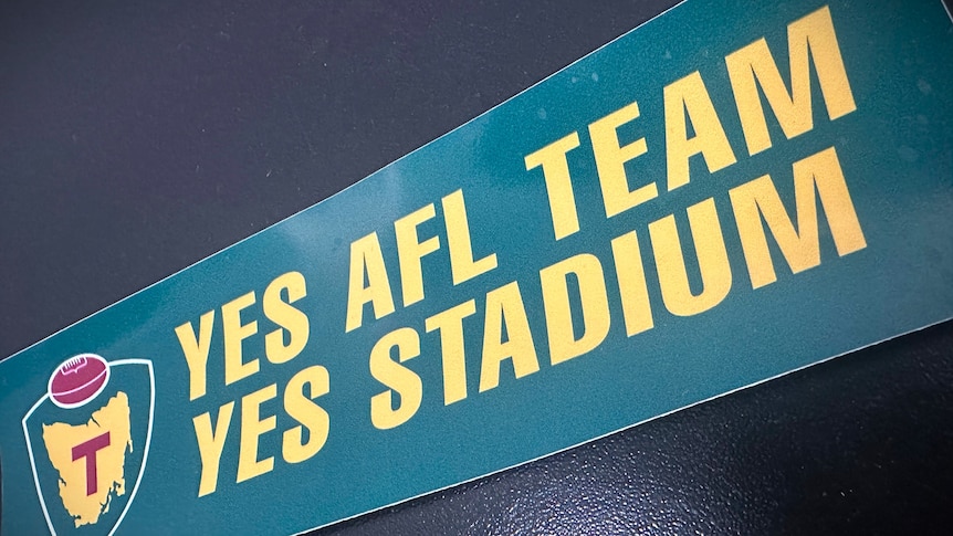 'Yes AFL team, yes stadium' sticker on a black background.