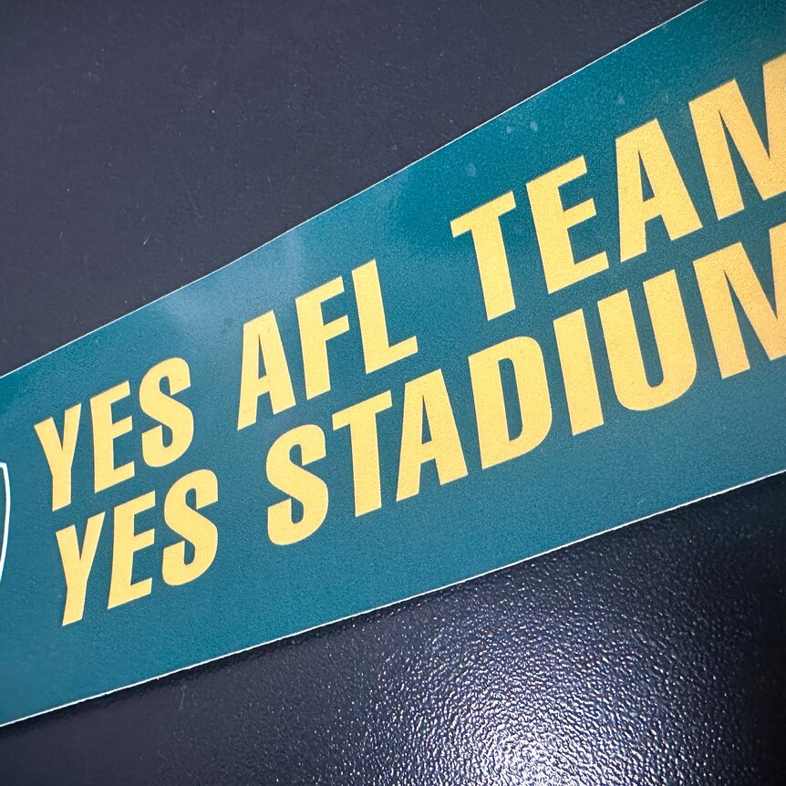 'Yes AFL team, yes stadium' sticker on a black background.