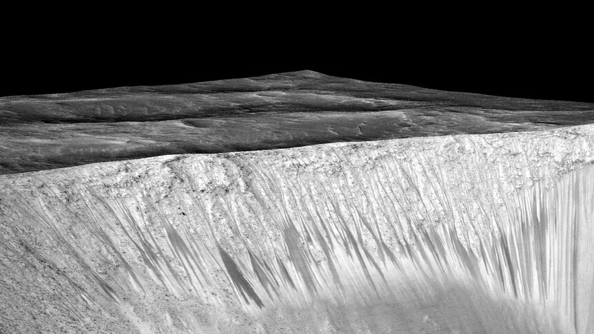 Dark narrow streaks coming out of the walls of Garni crater on Mars a few hundred metres in length