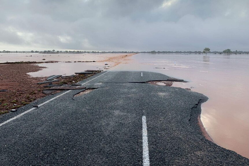 A flooded, damaged road.