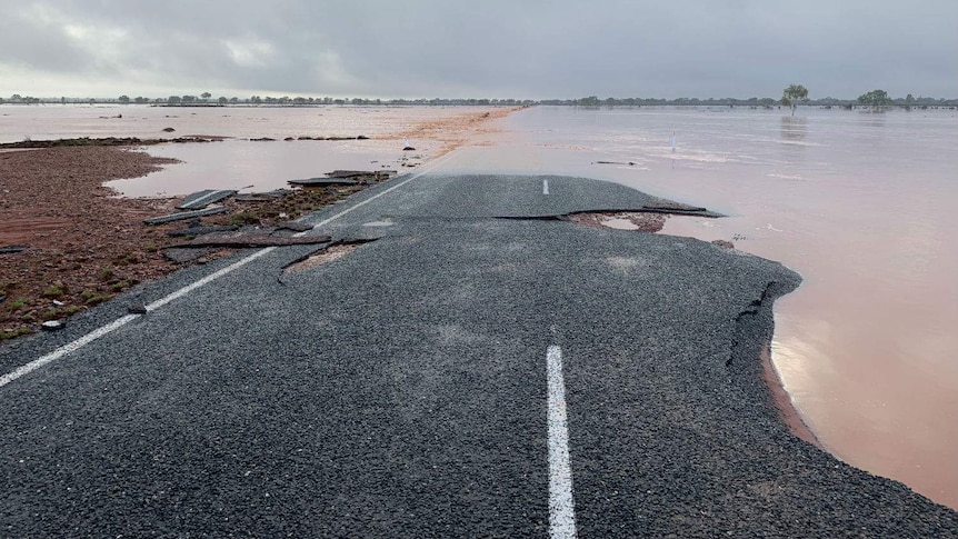 A flooded, damaged road.