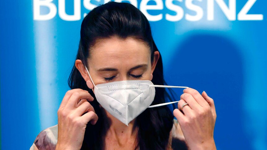 New Zealand Prime Minister Jacinda Ardern removes her mask 