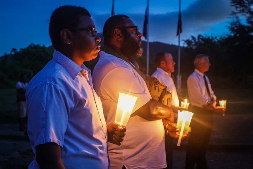 Men with candles in PNG. 