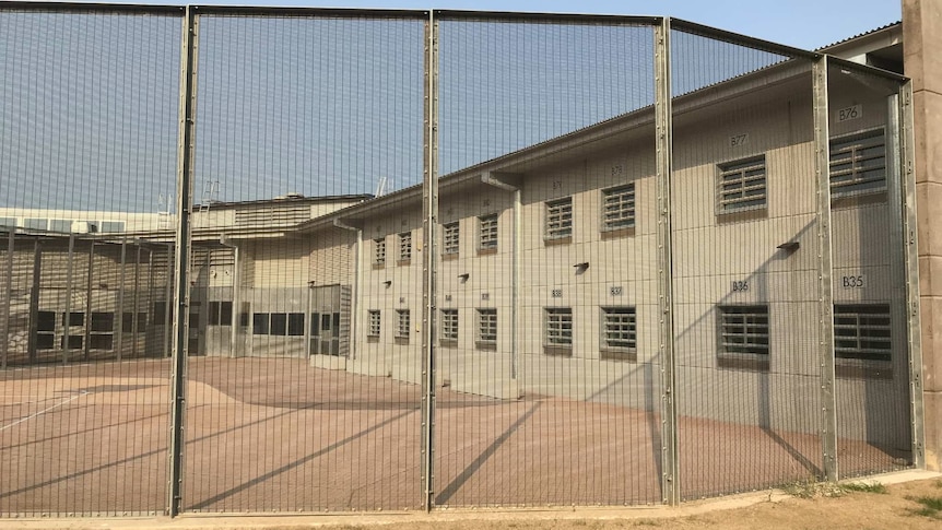 A prison building behind a gate
