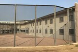 A prison building behind a gate