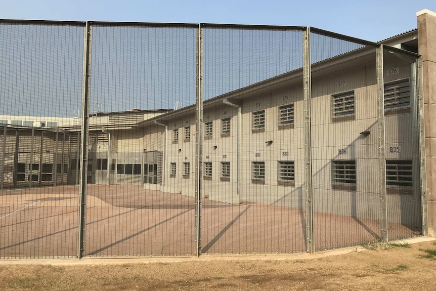 A prison building behind a gate