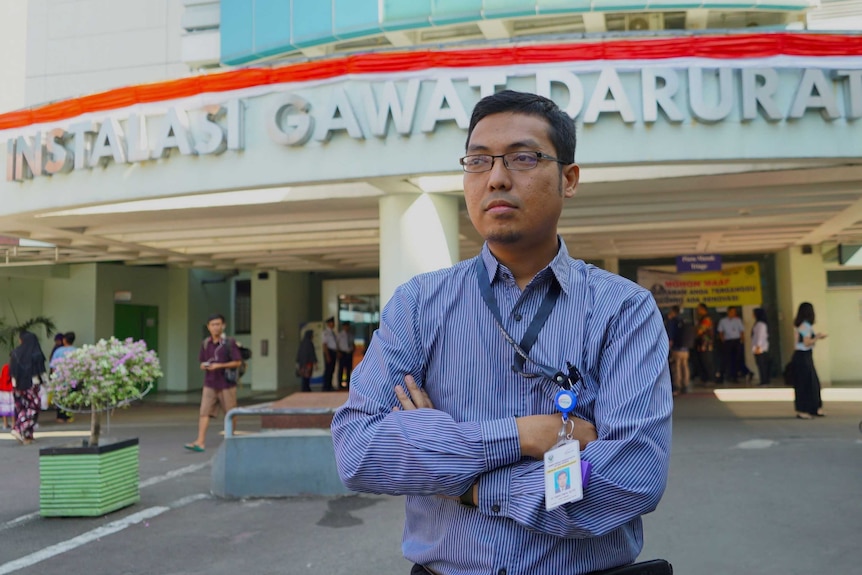 Doctor Hadiki Habib crosses his arms as he stands outside the Emergency Department he leads in Jakarta.