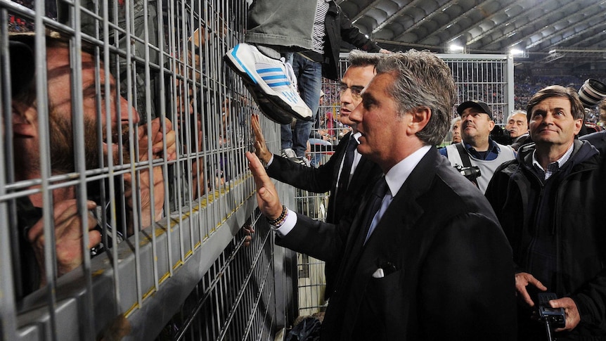 Sports director of Fiorentina, Daniel Prade, speaks to fans at the Italian Cup final with Napoli.