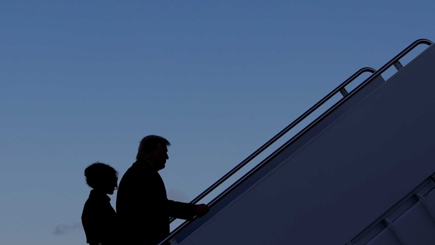 President Donald Trump departs next to first lady Melania Trump from the Joint Base Andrews, Maryland, U.S., January 20, 2021.