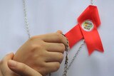 A Catholic nun wearing an anti-Reproductive Health ribbon