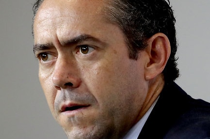 AFL football operations manager Simon Lethlean sits at a press conference.