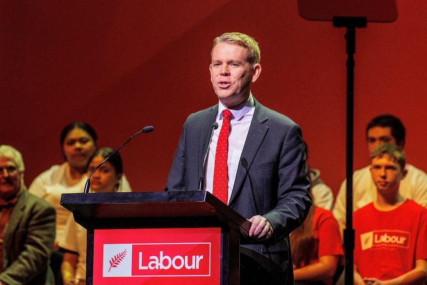 Chris Hipkins stands at a lectern during a Labour event 