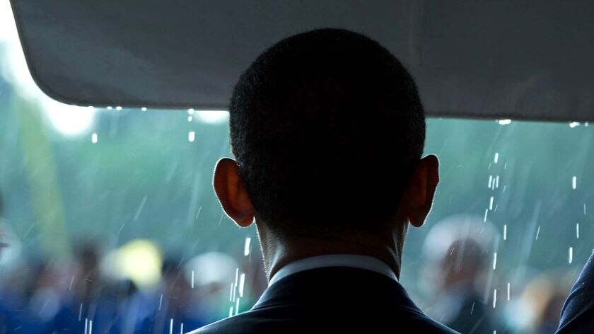President Barack Obama looks out into the rain