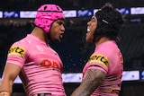 Two Penrith Panthers NRL players celebrate a try against the Sydney Roosters.
