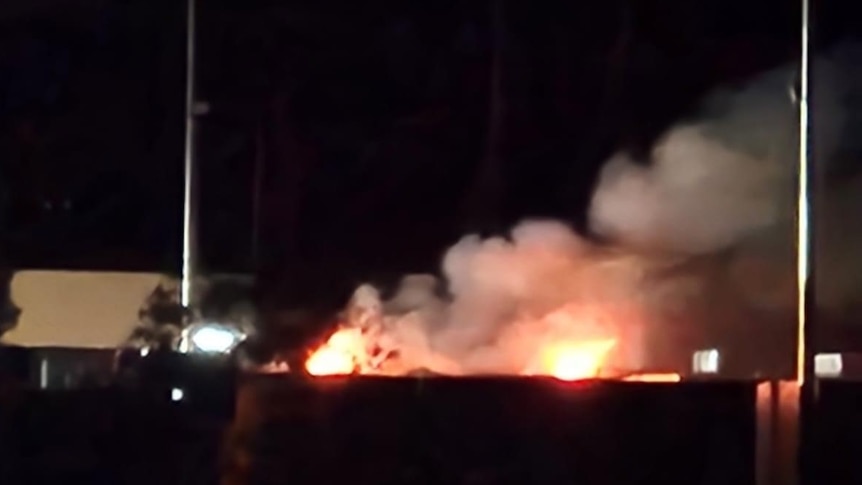 A fire at an industrial site at night.
