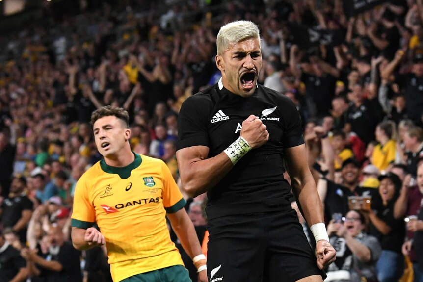 A New Zealand All Blacks player pumps his right fist after scoring a try against the Wallabies in Brisbane.