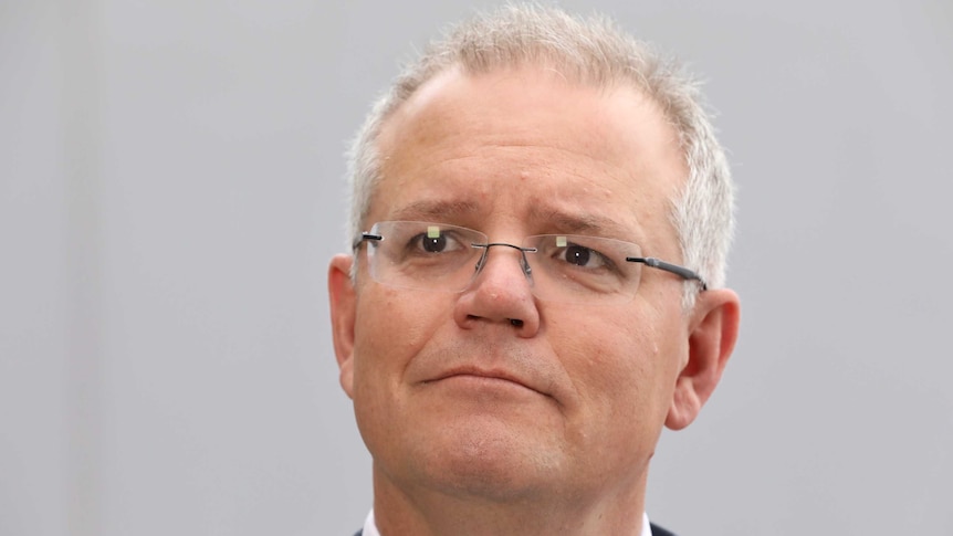 Prime Minister Scott Morrison listens as a journalist asks a question during a doorstop in Canberra