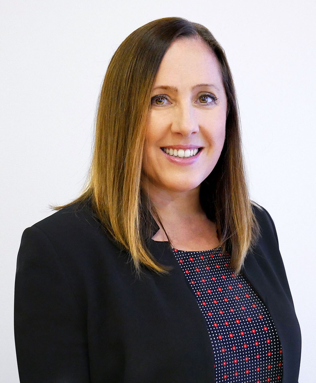 A portrait photo of a woman smiling.
